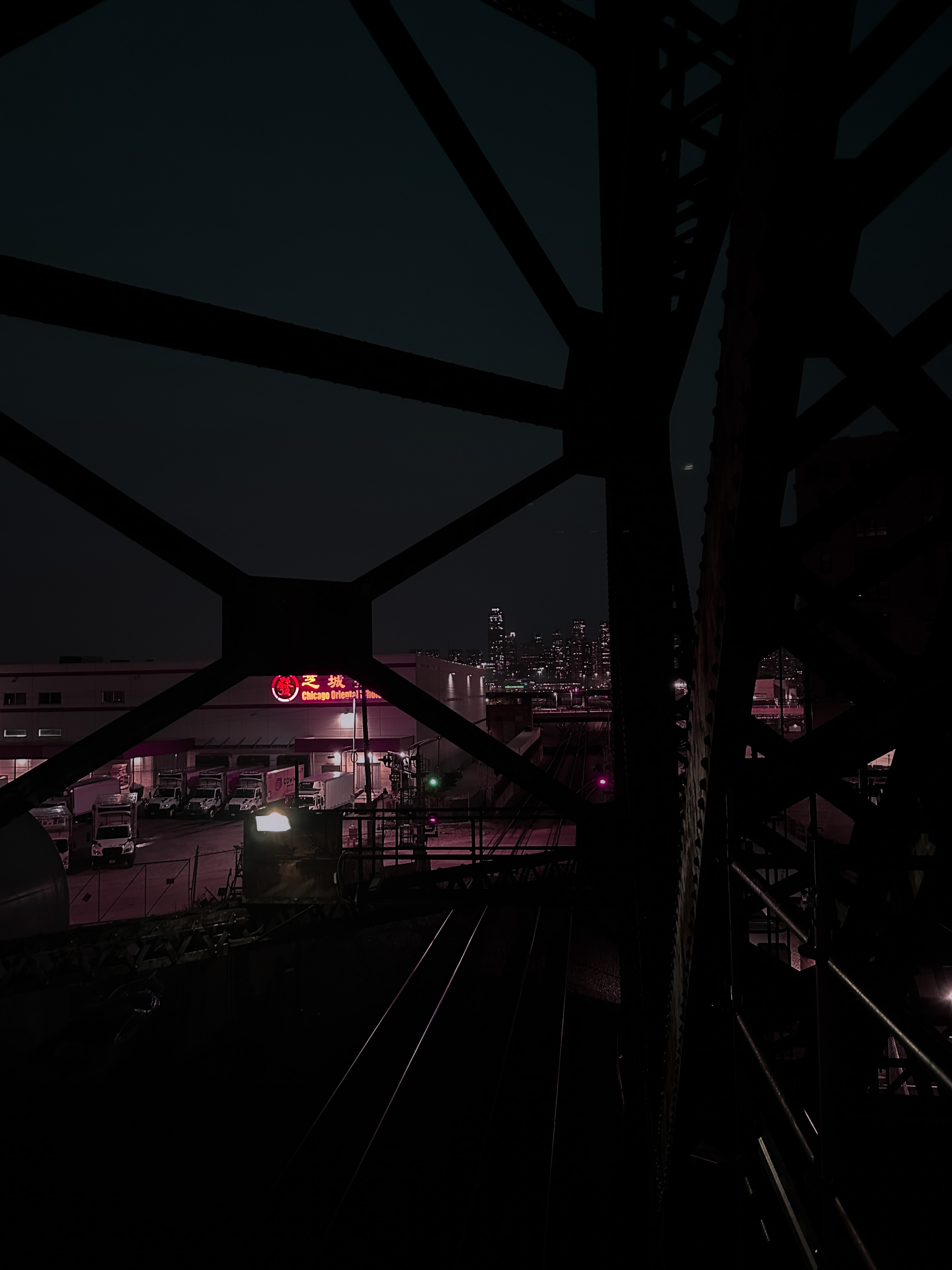 View from a bridge structure looking toward Chicago with Chinatown sign lit up